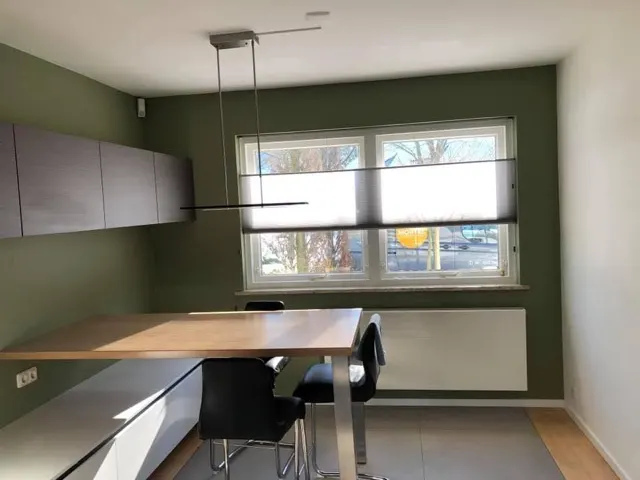 Groen getexte eetkamer met witte wanden en plafond