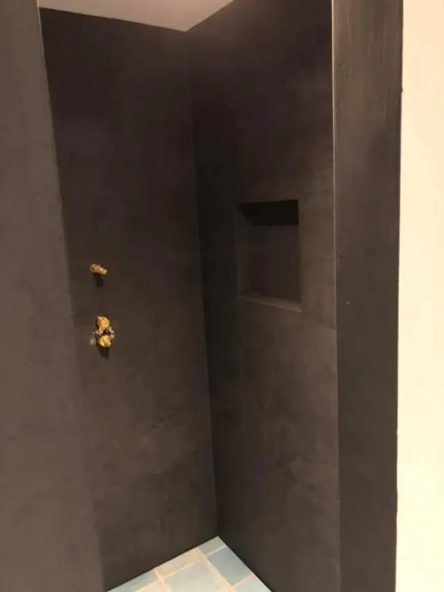 Donkere betonlook afwerking in een toiletruimte